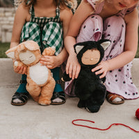 Image of 2 little girls playing with a black and tabby cat, soft plush toy doll for kids