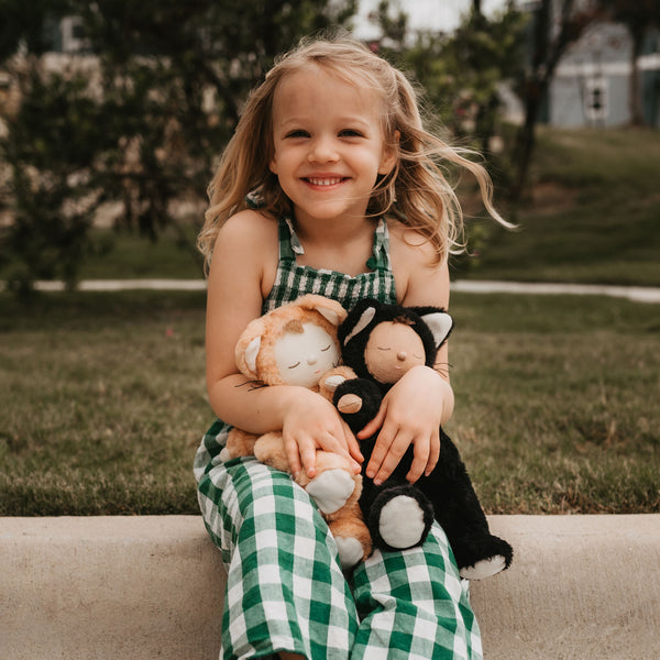 A Black Cat plush doll from the Cozy Dinkums range, designed for soothing snuggles and imaginative adventures. Soft black cat toy, perfect for all ages bedtime and comfort.