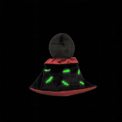 Black and red hat with green glowing eyes on a black background