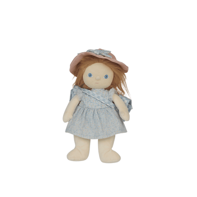 Stuffed doll with a blue dress and pink hat on a black background