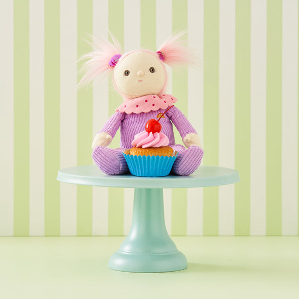 Limited-edition, palm sized, collectable corduroy kids plush toy. Clara Cupcake is a pink and purple weighted plush toy in a velvet onsie, perfect for imaginative kids play.