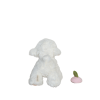 White plush dog toy with a pink and green object on a white background