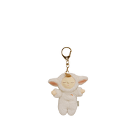 Plush keychain of a baby doll in a white outfit with gold chain on a white background