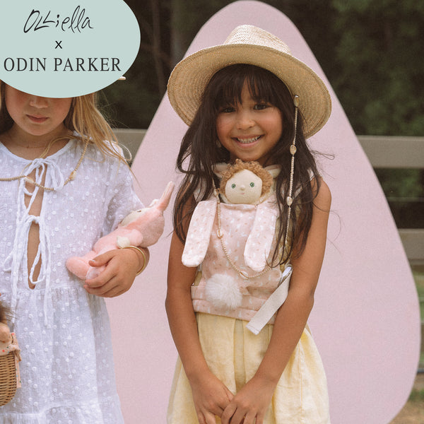 A cozy, bunny-themed pink doll carrier with adjustable straps, perfect for little ones to carry their favorite dolls on adventures. Ideal toddler toy accessory, cuddly easter-themed doll carrier.