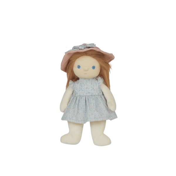 Stuffed doll with a pink hat and light blue dress on a black background