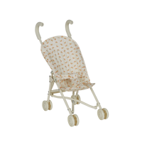 Miniature stroller with a patterned canopy on a white background