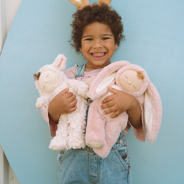 Soft and cuddly pink bunny plush doll with floppy ears. Posable and gently weighted for a calming presence. This bunny soft toy is the ideal companion from birth.