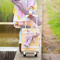 Soft-doll with purple check printed onesie, perfect as a childs travel companion strapped to our see-ya suitcase.