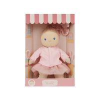 Toy doll in a pink outfit inside a cute house-like box