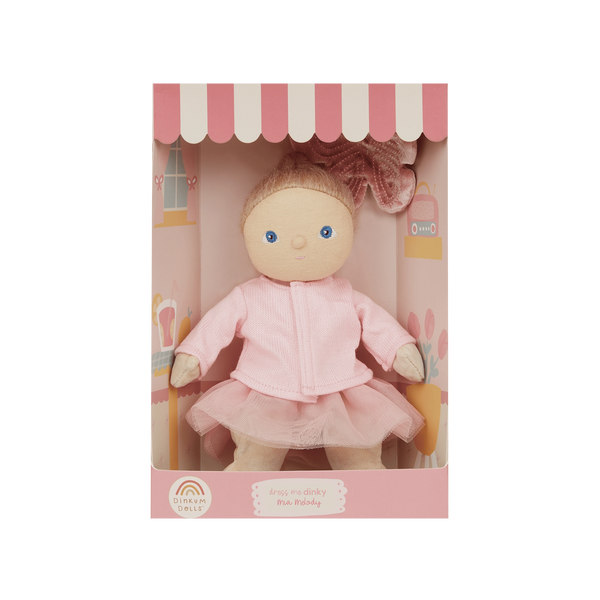 Toy doll in a pink outfit inside a cute house-like box