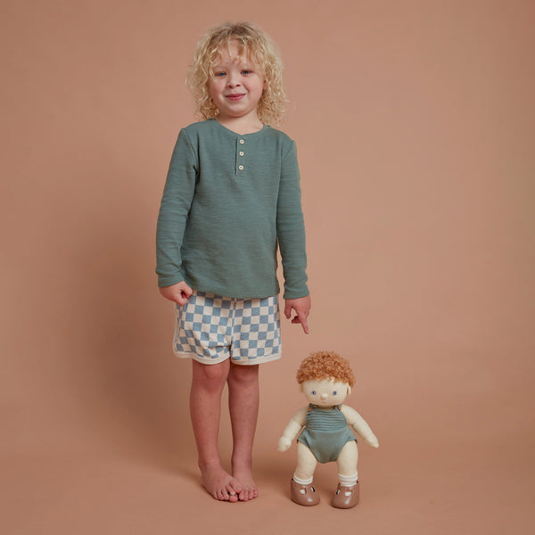 Ginger haired, posable doll for kids. Snuggle them, dress them up and style their hair. Each Doll comes with its own removable gender-neutral outfit, socks, nappy, and shoes, perfect for interactive doll play.