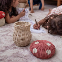 Pink rattan mushroom basket with coloured pencils for kids.