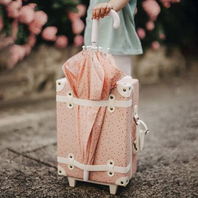 Olli Ella See Ya Umbrella pink with daisy print pictured with the pink diasy suitcase