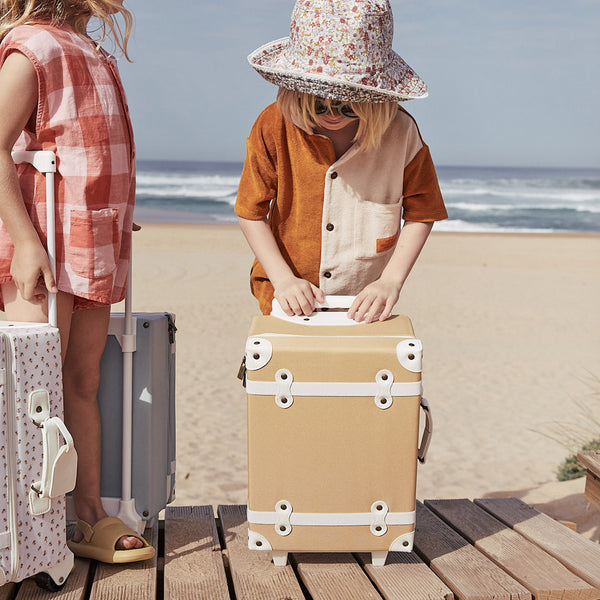 The ultimate kids travel suitcase. Yellow suitcase for kids holidays, with straps to carry their favourite doll / toy.